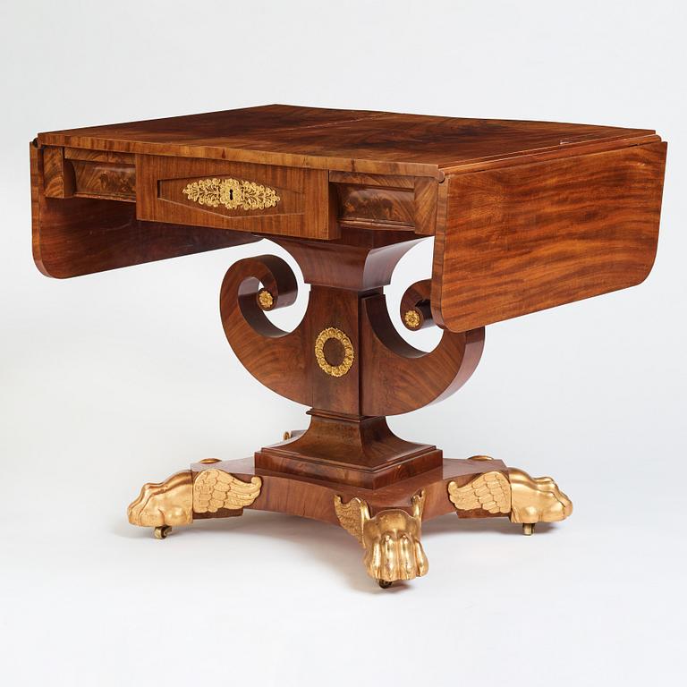 A Swedish Empire mahogany center table by Johan Öman, (Stockhom 1815-1833).