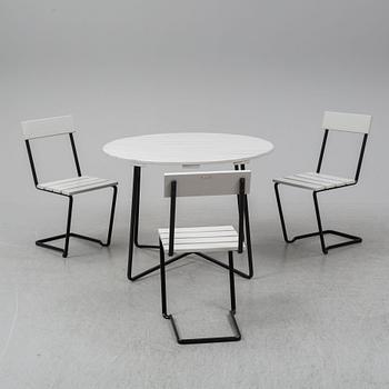 A Grythyttan garden table and three chairs.