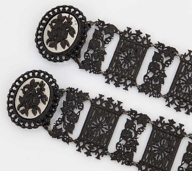 A Berlin steel and iron parure comprising a necklace, two bracelets and a brooch.
