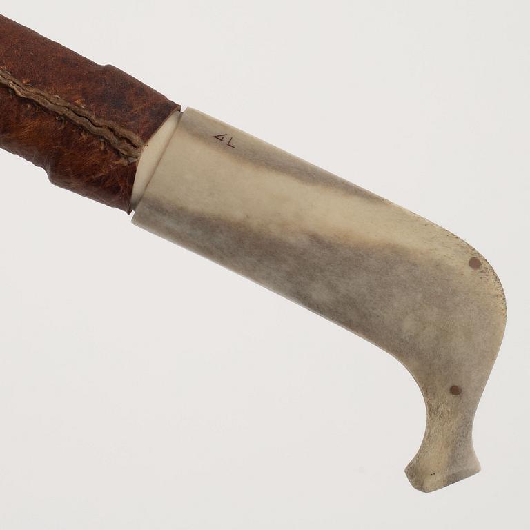 A reindeer horn knife, signed AL.