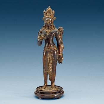 1858. A Sino-Tibetan bronze figure of Padmapani, standing in slight tribhanga pose, 18th Century.