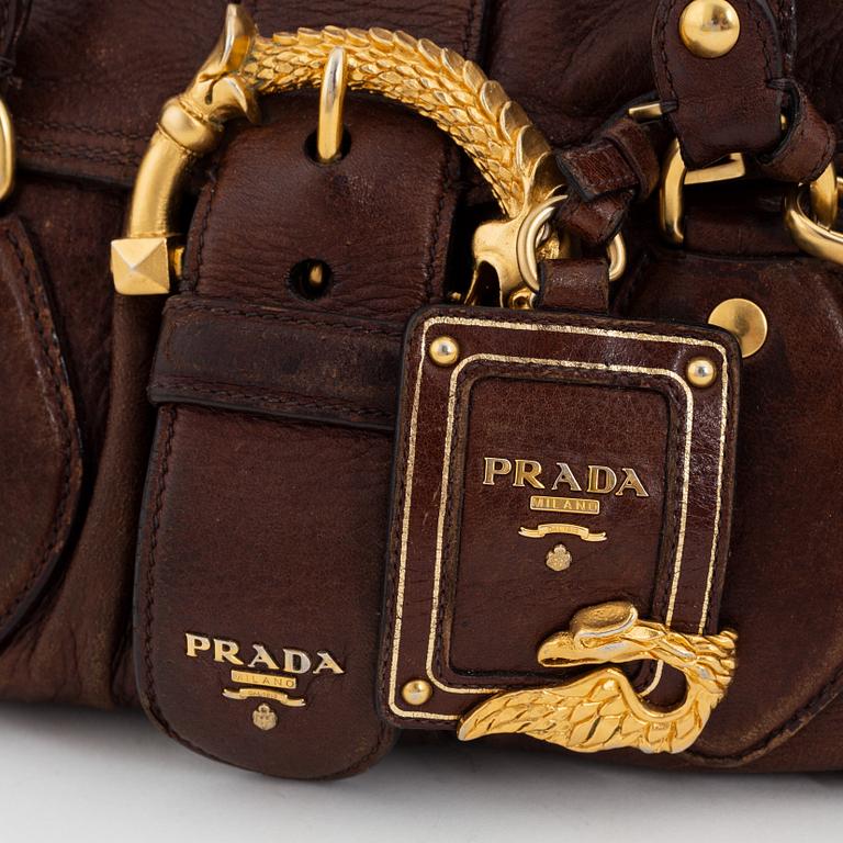 Prada, a brown leather bag.