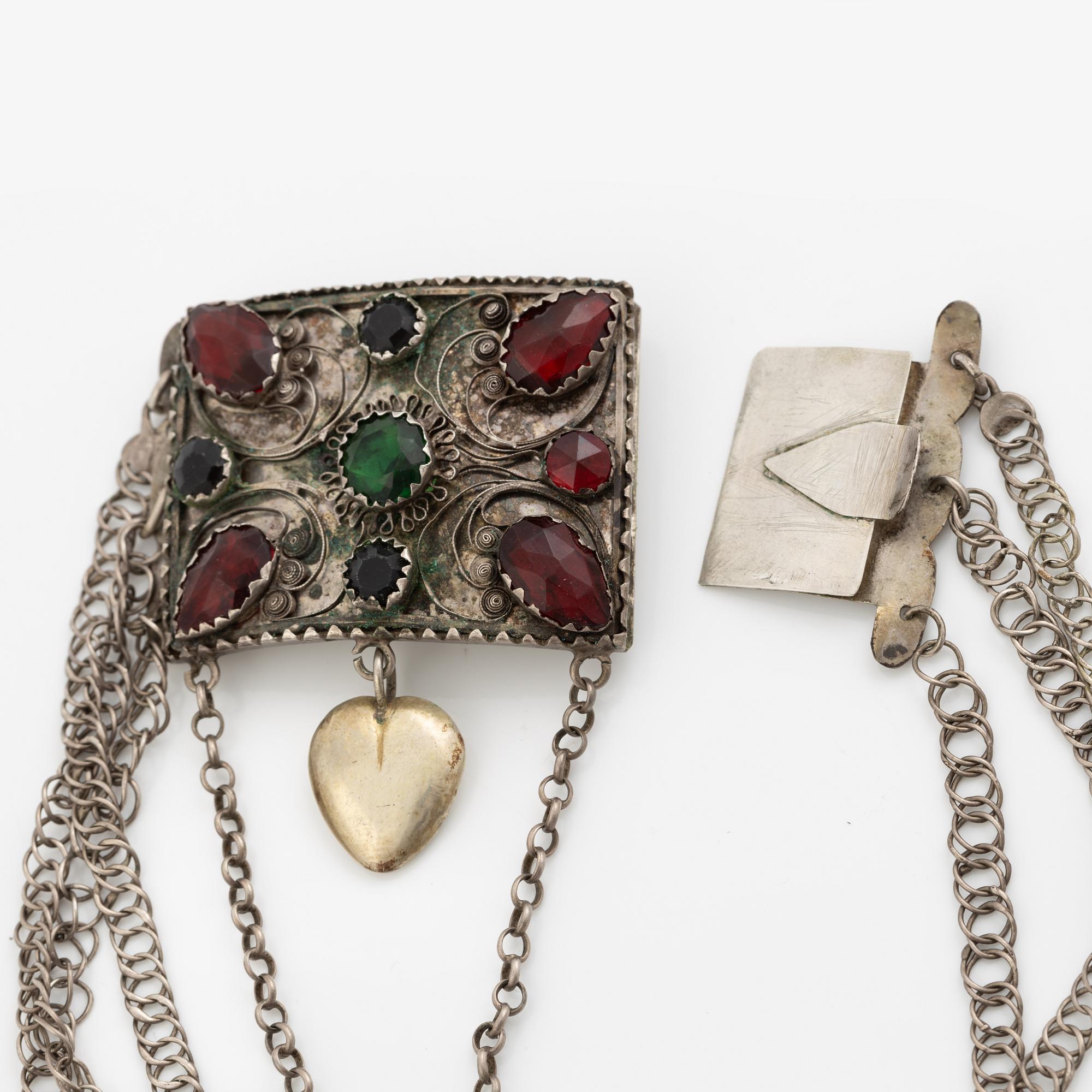 Folk costume jewellery, silver with glass stones.