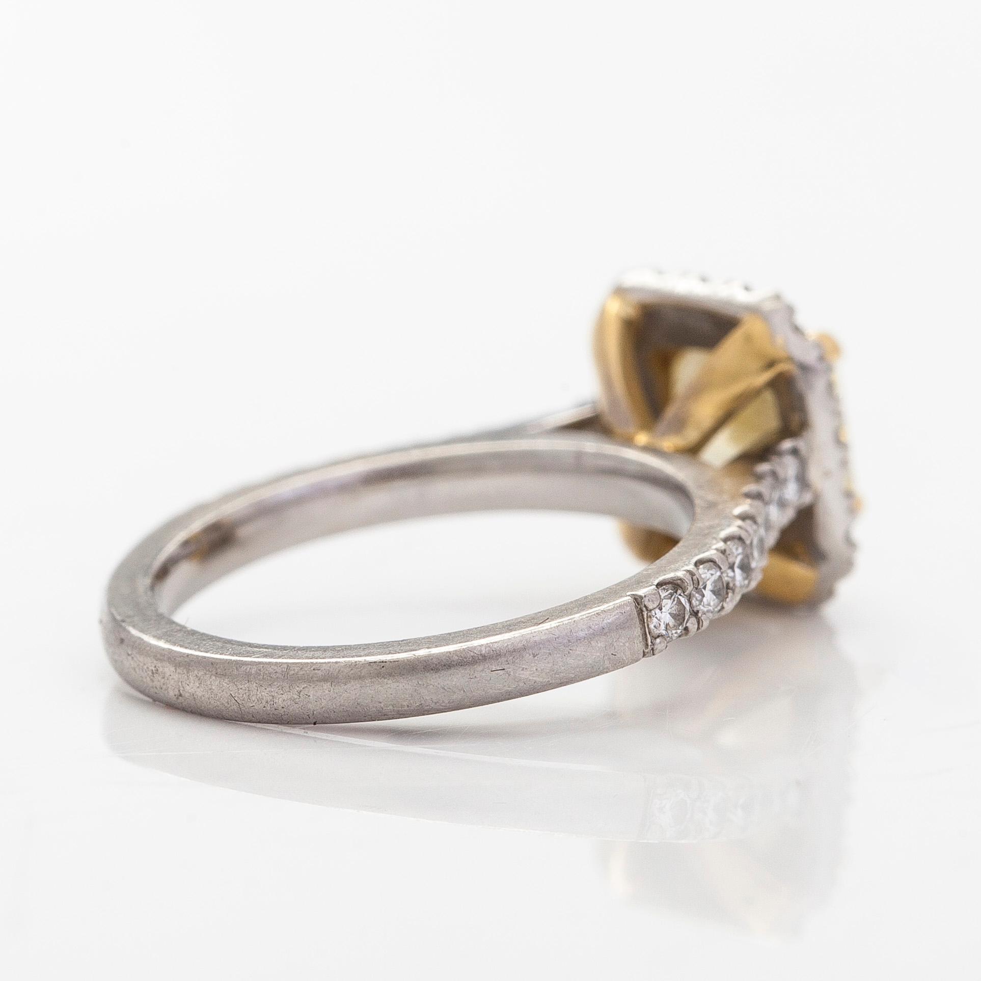 platinum ring with yellow radiant-cut diamond and brilliant cut diamonds.