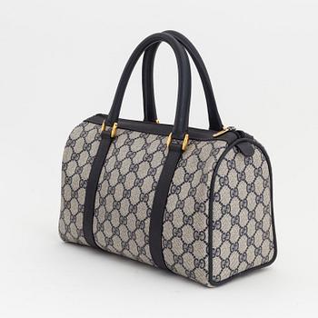 Gucci, a monogram canvas bag.