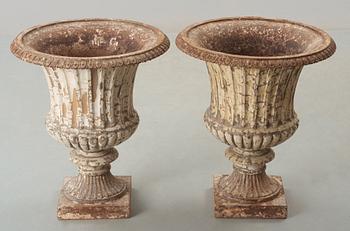 A pair of English 1860's iron garden urns.