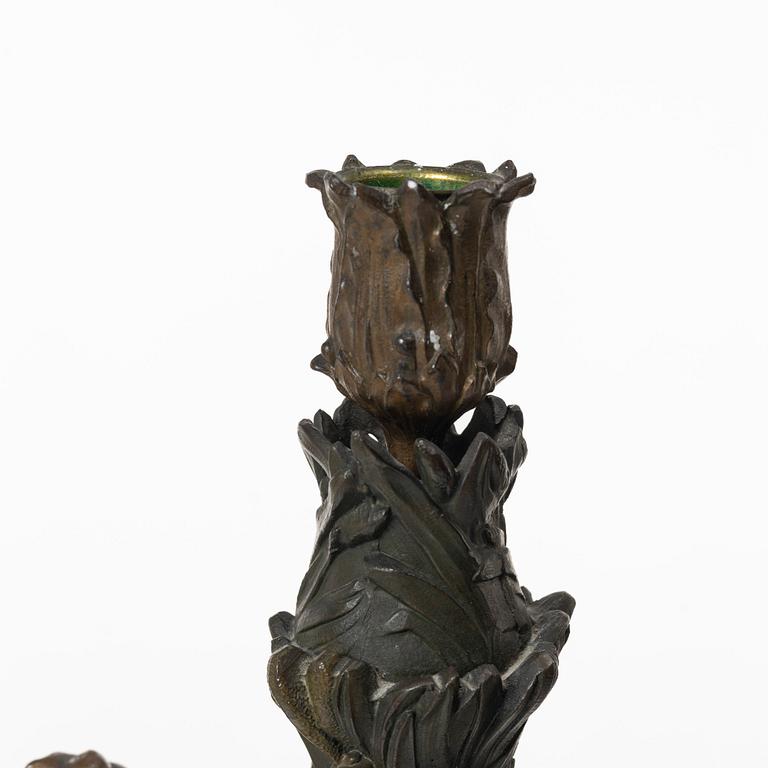 a pair of bronze and marble candle sticks, after a model by Houdon, late 19th century.