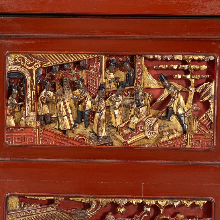 A Chinese cabinet, early 20th Century, with 19th Century carved panels.