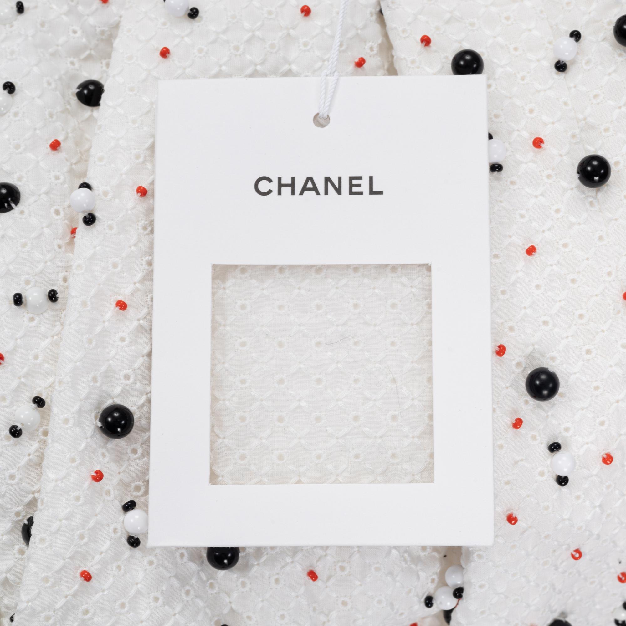 Chanel, a pair of broderie anglais trousers with pearls, size 34.