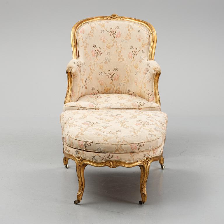 A Louis XV-style bergère armchair with stool, second half of the 19th century.