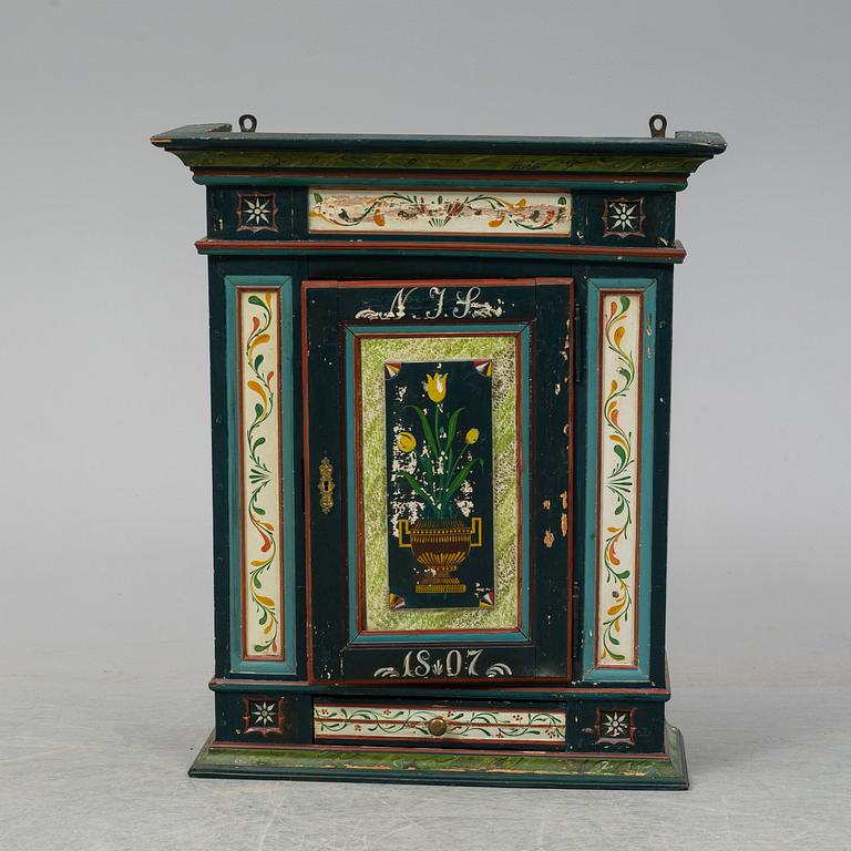 A painted wall cabinet, 19th century.