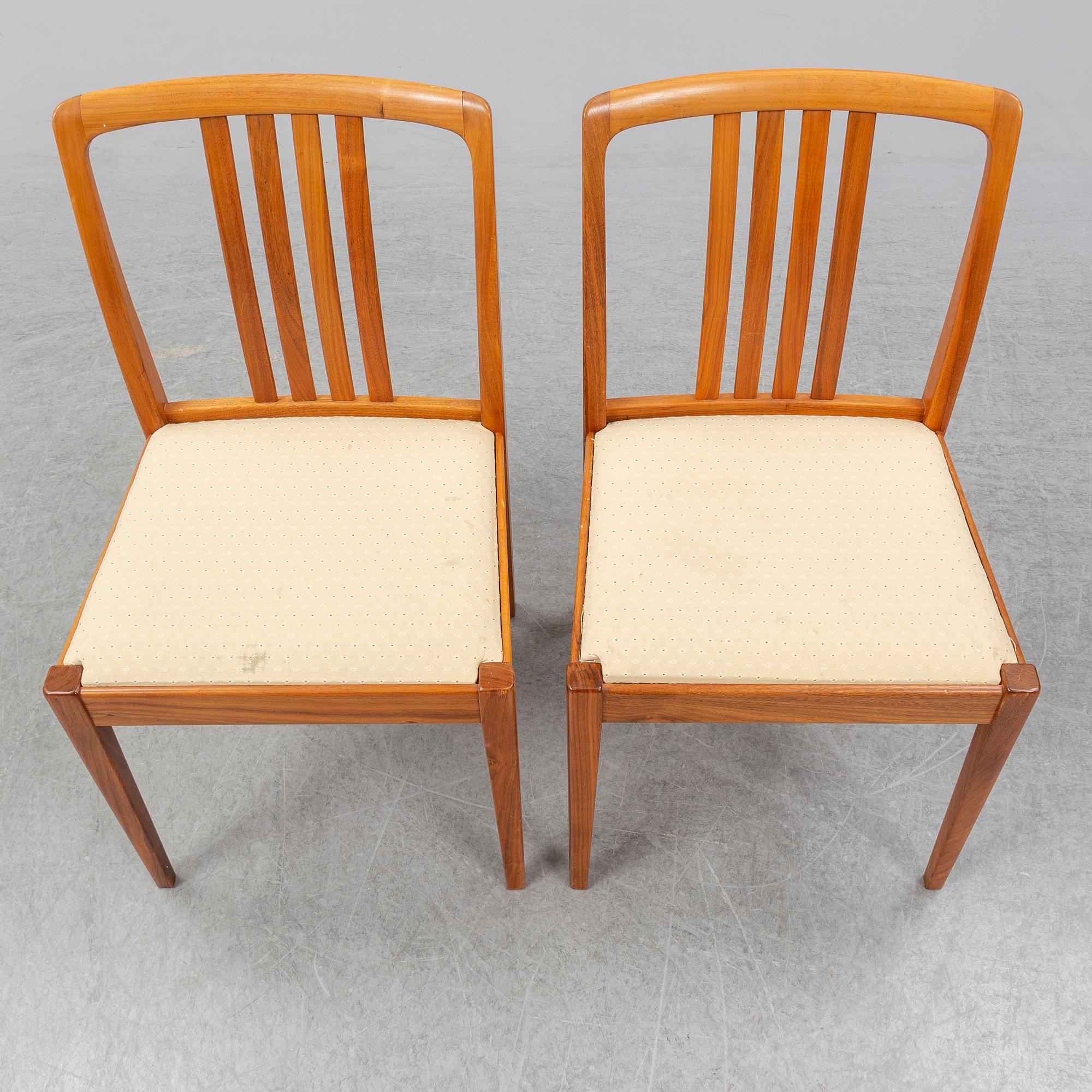 A 1950/60s teak and valnut table and four chairs.
