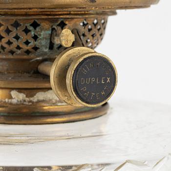 A brass and glass column shaped paraffin lamp, end of the 19th Century.