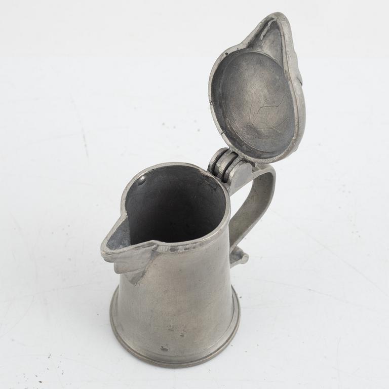 A pewter measuring cup by an unidentified master, dated 1766.