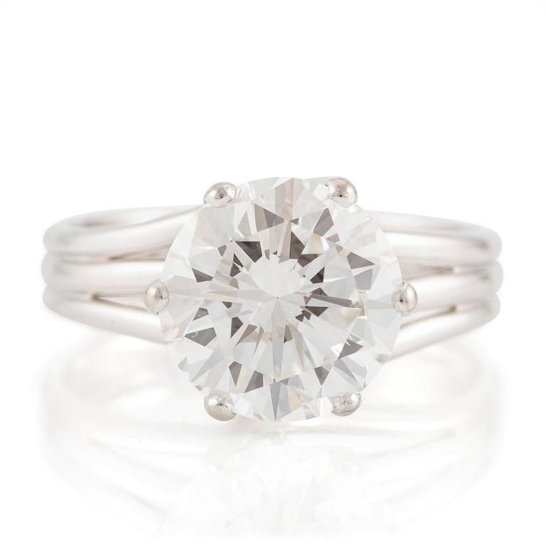 A ring in 18K white gold set with a round brilliant-cut diamond.
