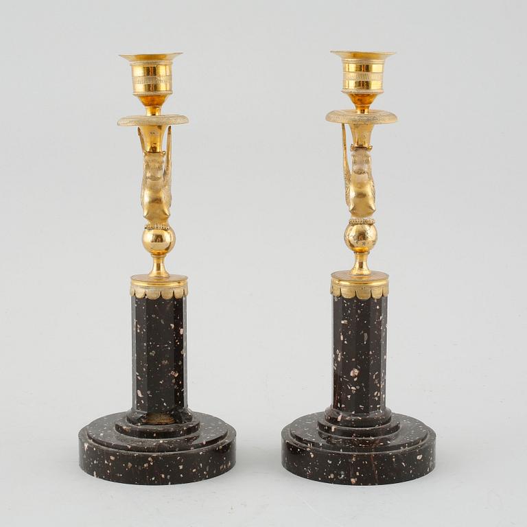 A pair of late Gustavian early 19th century porphyry and ormolu candlesticks.