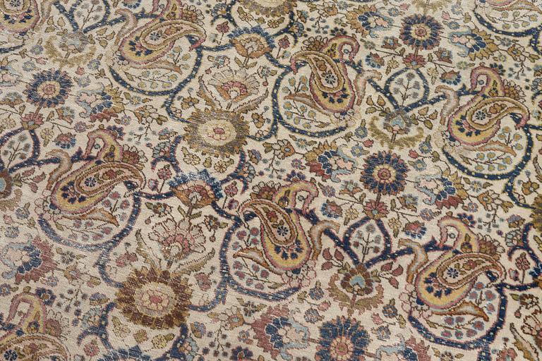 A Tabriz carpet, semi-antique, c. 330 x 230 cm.