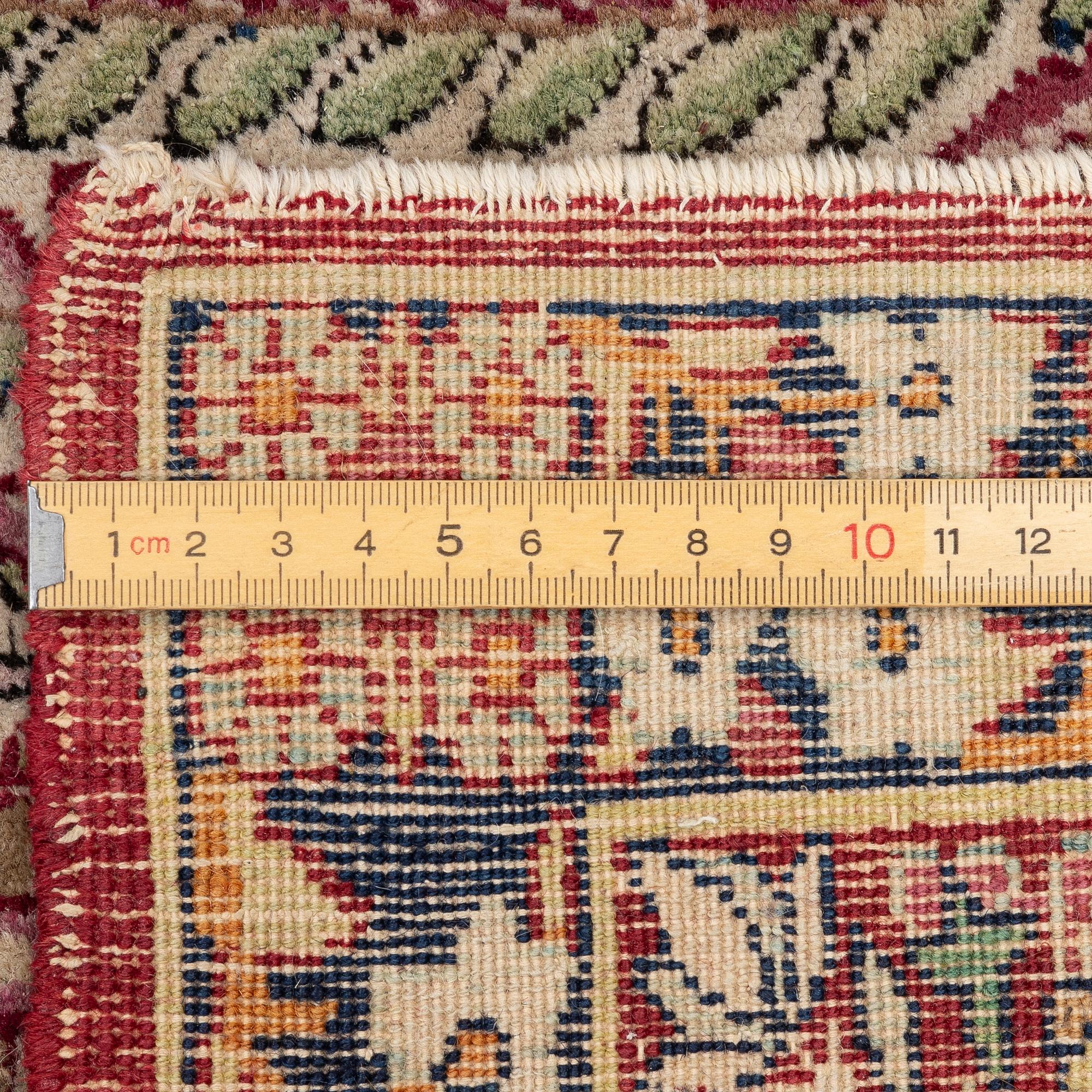 An antique Kirman rug, south Persia, c. 220 x 140 cm.