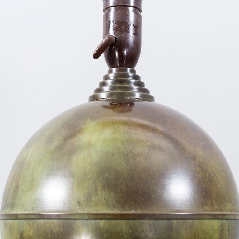 A patinated table lamp from the first half of the 20th century.