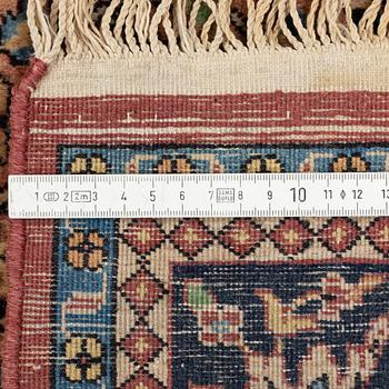 An oriental rug, circa 245 x 136 cm.
