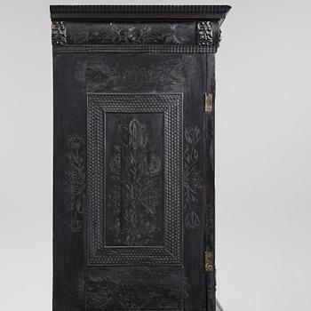 A Louis XIV and Louis XIV-style carved ebony, ivory and tortoiseshell-inlaid cabinet on stand, 17th and 19th century.