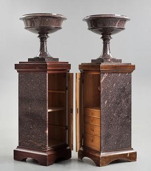 A pair of Swedish porpyry vases on wooden bases, Älvdalen, first half of the 19th century.
