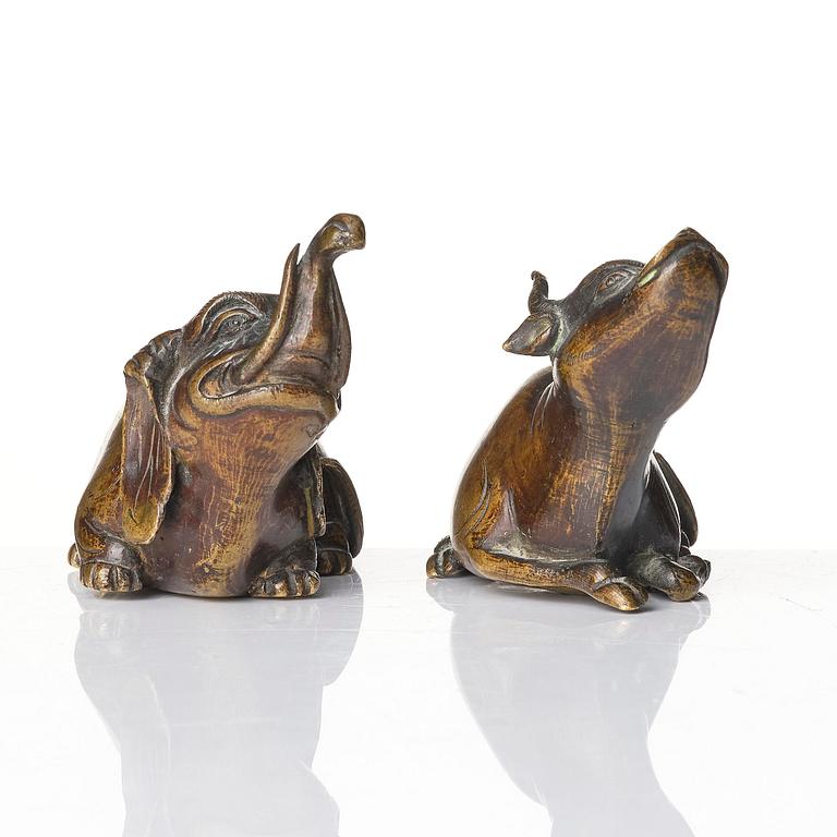 A set of two bronze scroll weights/sculptures, late Ming dynasty/early Qing dynasty.