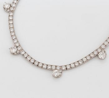 A Cartier necklace in platinum and 18K gold set with round brilliant-cut diamonds.