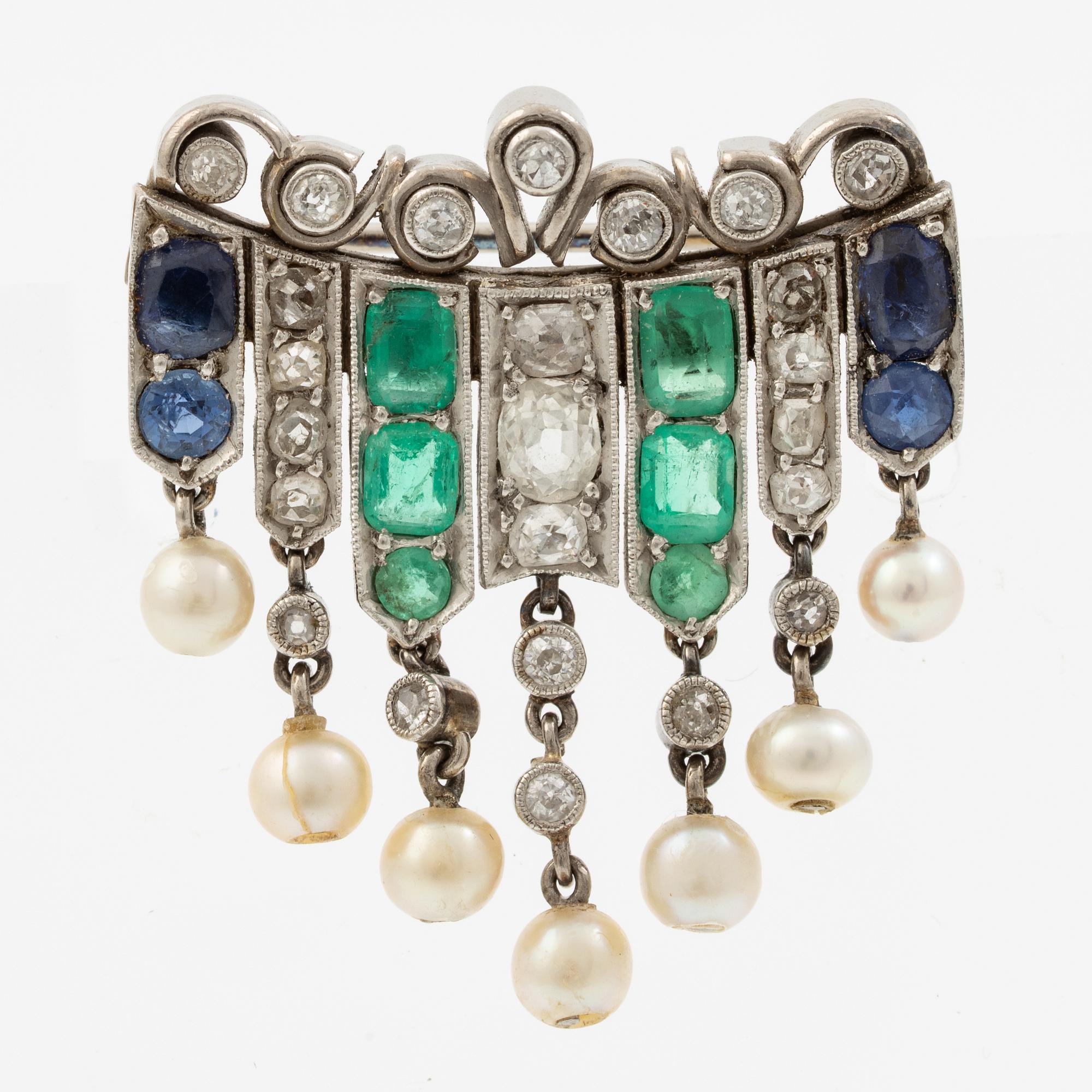 Brooch in platinum set with old-cut diamonds, sapphires, emeralds, and pearls.
