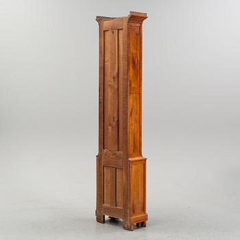A walnut long case clock, from around the year 1900.