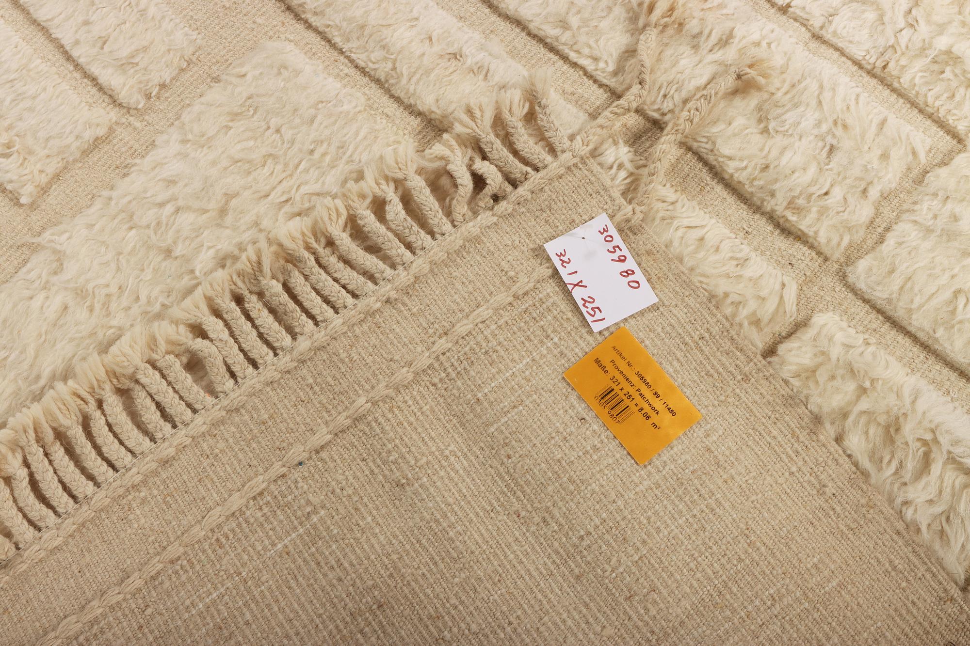 A relief-cut Moroccan carpet, c. 321 x 251 cm.