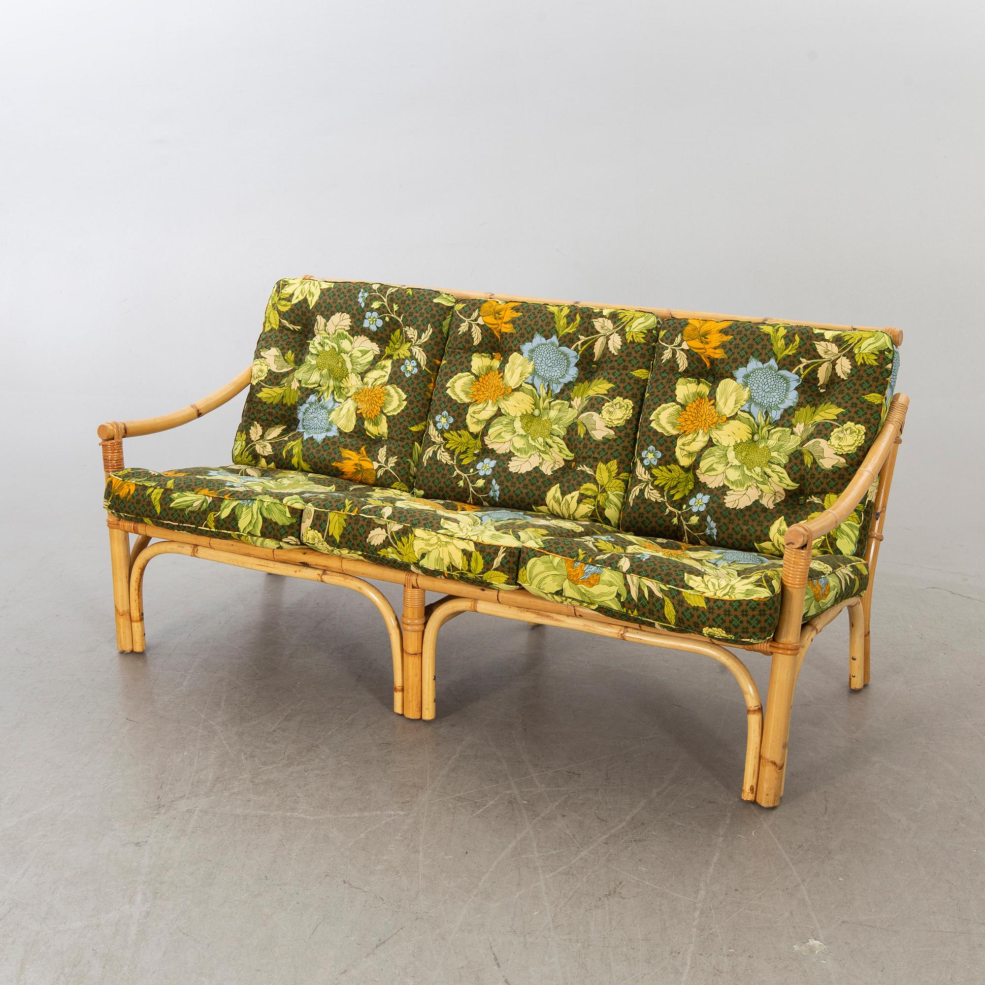 A set of ratten furniture, late 20th century; sofa, armchairs and a lounge table.