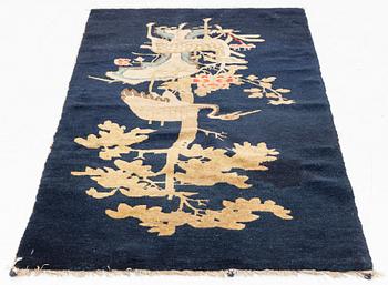 A Rug, a semi-antique Baotou figural, China, ca 127-128 x 67,5 cm.