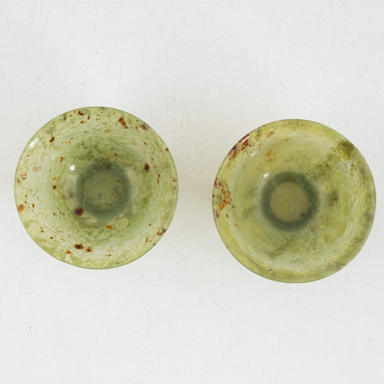 A pair of Chinese green stone bowls.