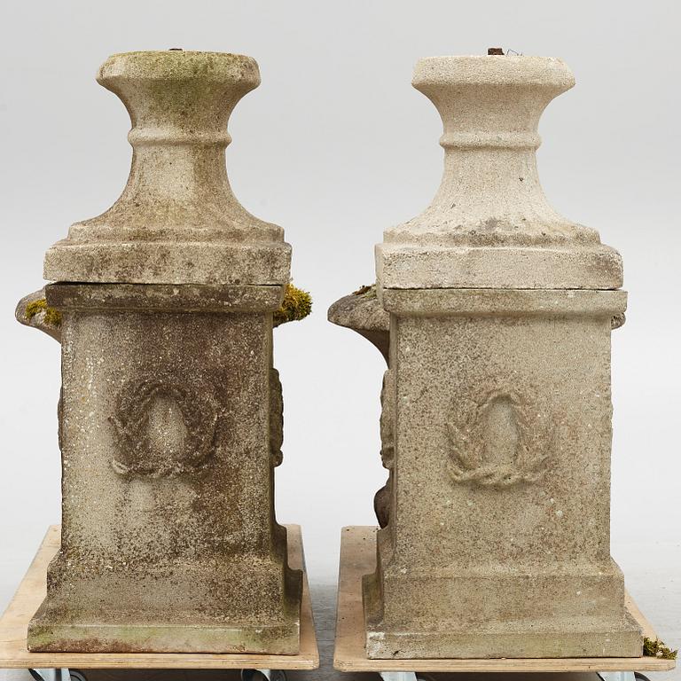 Garden urns, a pair on pedestals, 20th century.