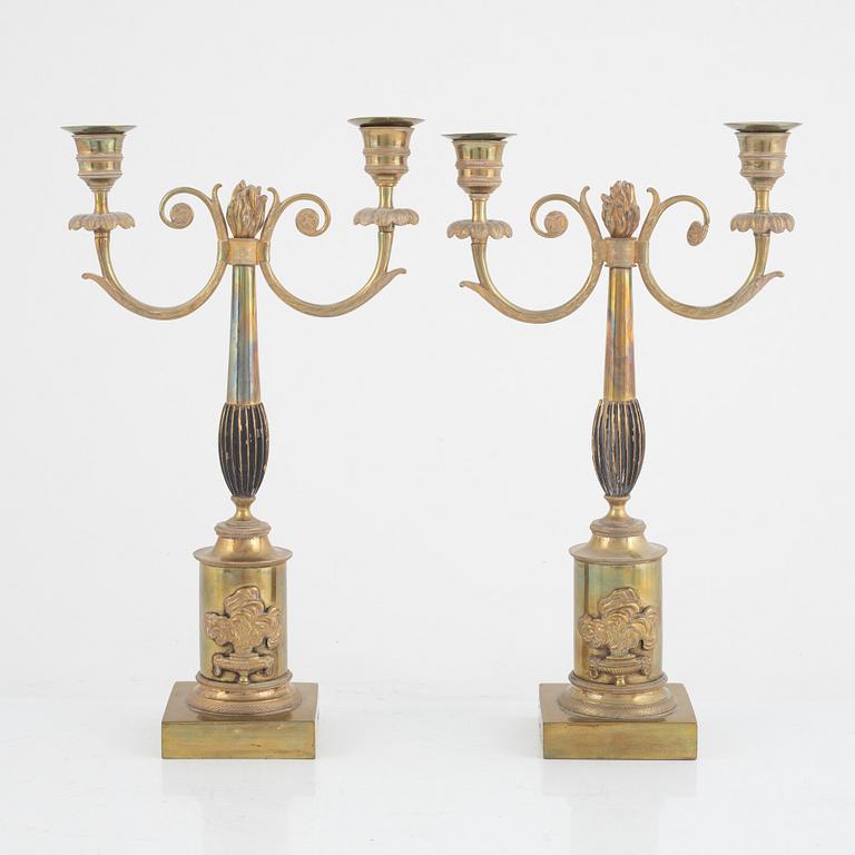 A pair of Swedish Empire two-branch gilt-brass candelabra, 1820's/30's.