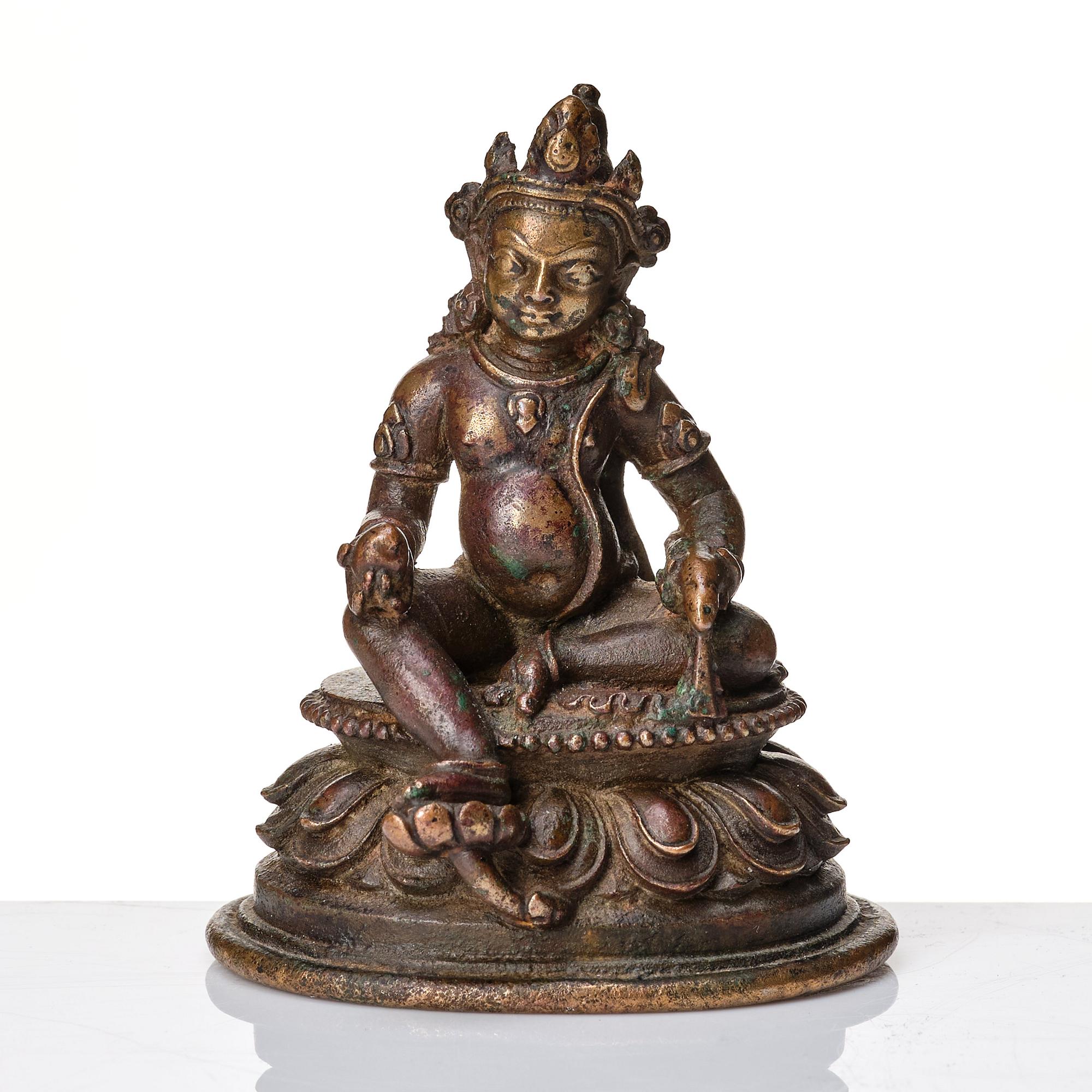 A copper alloy figure of Jambhala, Nepal, possibly 12/13th Century.