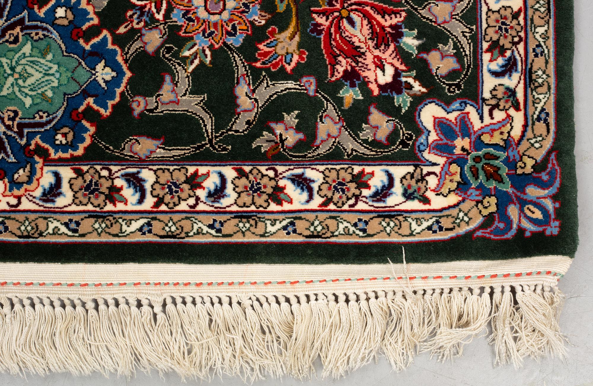 A rug, old Esfahan, part silk, signed, ca 225 x 149 cm (ca 1,5-2,5 cm flat weave at the ends).