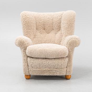 A sheepskin upholstered lounge chair.