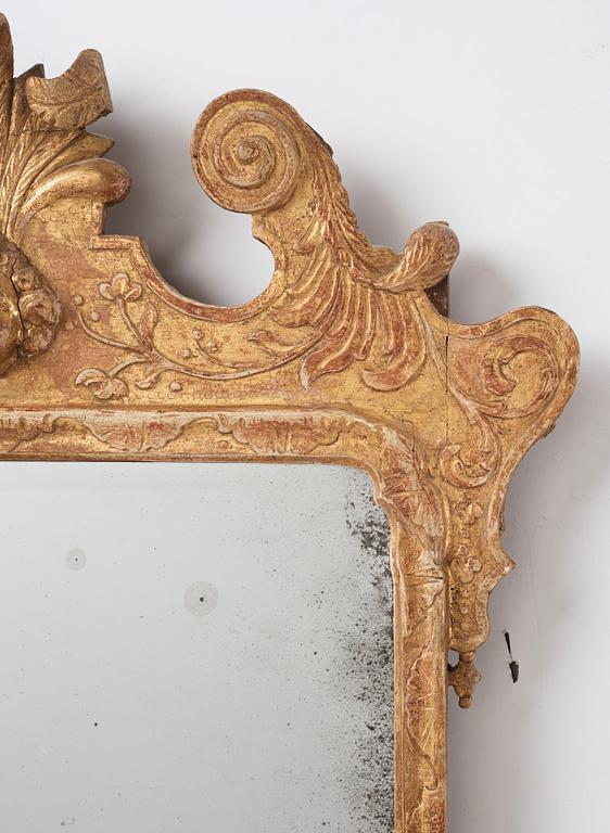 A Northern-European late Baroque two-light giltwood mirror sconce, first part of the 18th century.