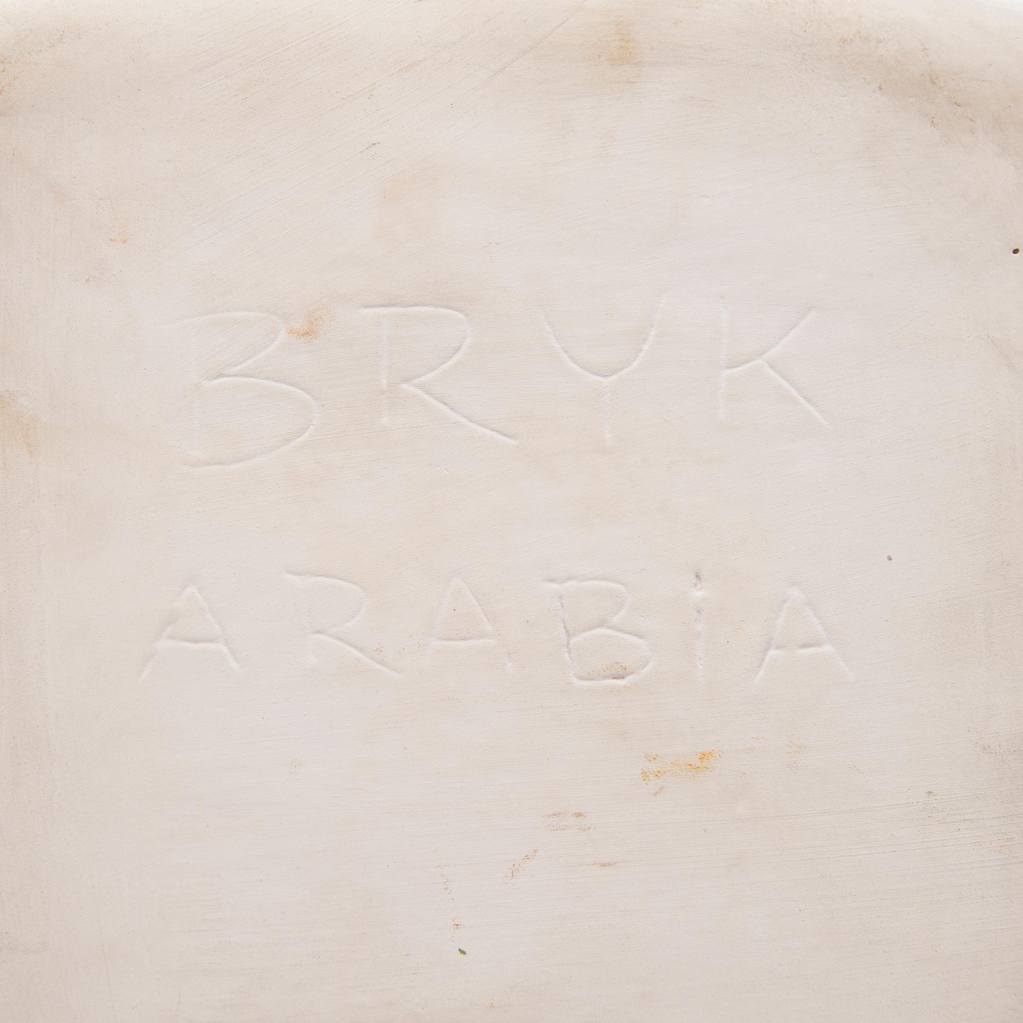 A ceramic plate signed Bryk Arabia.