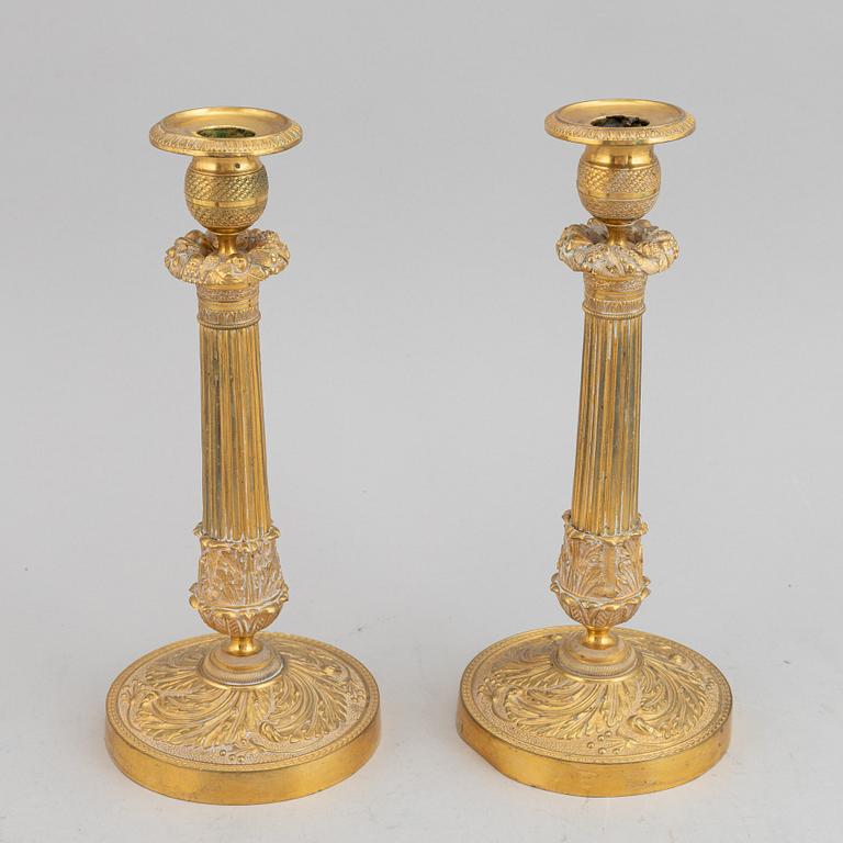 A circa 1900 empire style brass candlesticks.