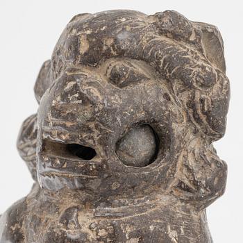 A stone scroll weight/sculpture of a buddhist lion, China, presumably Qing dynasty (1664-1912).