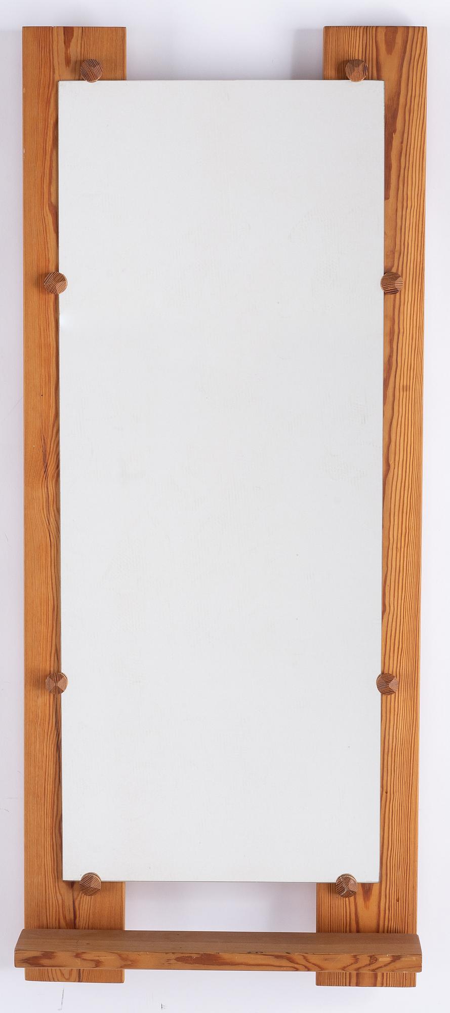 A pine mirror by Gunar Kanevad, signed and dated 1971.