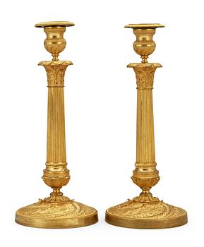 680. A pair of French Empire early 19th century candlesticks.