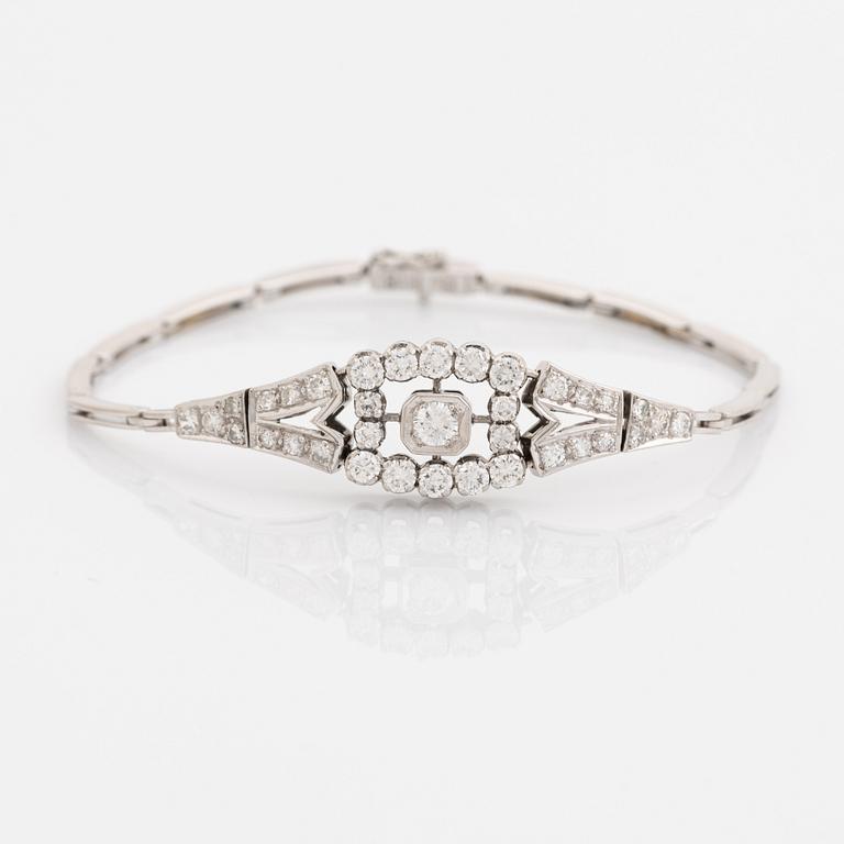 An 18K white gold bracelet set with round brilliant- and eight-cut diamonds.