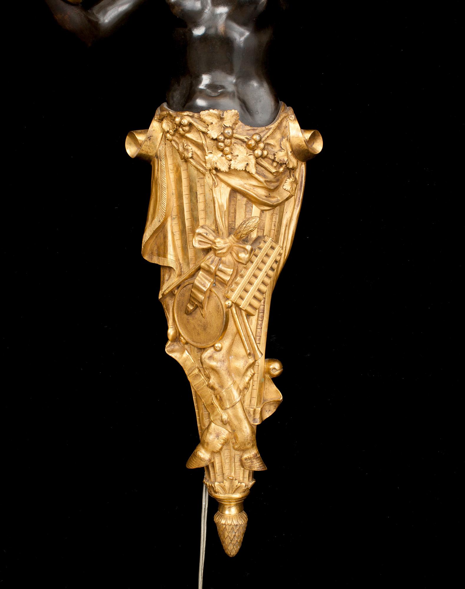 A pair of Louis Philippe 1830/1840's gilt and patinated bronze four-light wall-lights.