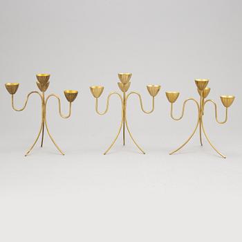 Gunnar Ander, a set of three brass five-light candelabra from Ystad Metall.
