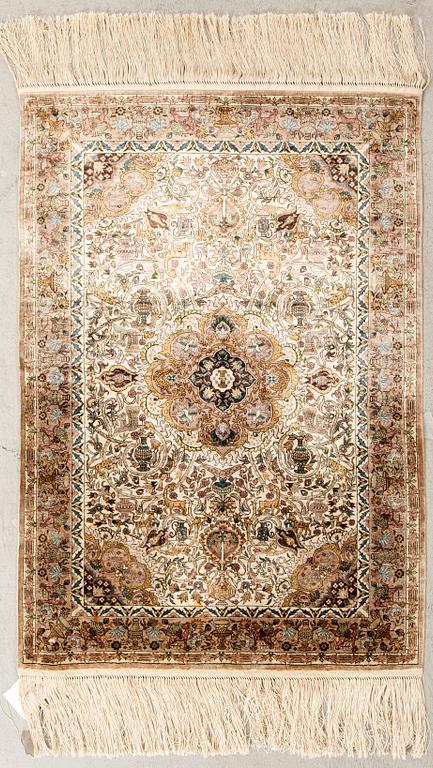 An Oriental silk carpet ca 91x62 cm.