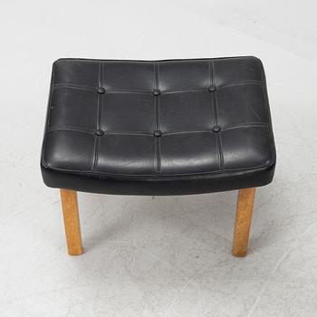 A 1970's teak and pvc coated fabric armchair and stool.